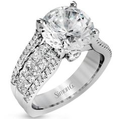 a white gold engagement ring with two rows of diamonds on the band and an oval center stone