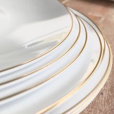 white and gold plates stacked on top of each other