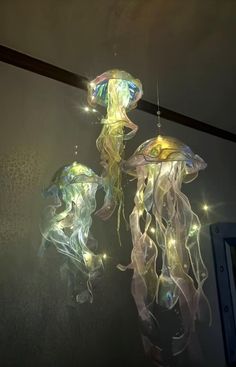 two jellyfish lights are hanging from the ceiling