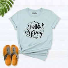 Hello Spring Shirt, spring shirts for women, Easter Shirts, Floral Spring T-Shirt, Spring Flowers Shirt, spring day t-shirt, spring clothing Hello! Thank you for supporting small businesses. My main priority here is the satisfaction of my customers. My t-shirts are Bella+Canvas brand. If Bella+Canvas is out of stock, I will send it from a brand of the same size and quality. If you want to see this design on the SWEATSHIRT you can buy it from the link below.https://etsy.me/3LS0Viz T-shirts are co Green Casual T-shirt For Spring, Spring Letter Print Short Sleeve T-shirt, Spring Letter Print Relaxed Fit T-shirt, Trendy Cotton Shirt For Spring, Spring Graphic Tee Cotton Tops, Spring Cotton Graphic Tee Tops, Spring Graphic Cotton Tee, Green Letter Print Top For Spring, Spring Green Top With Letter Print