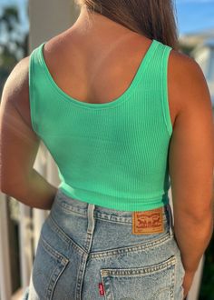 Introducing The Bryer Crop - the ultimate ribbed tank with a playful twist! With its button top design and cropped style, this top is perfect for adding a touch of fun to any outfit. Stay trendy and comfortable in The Bryer Crop! Everyday Green Seamless Crop Top, Green Cropped Top For Everyday, Green Cropped Top For Everyday Wear, Casual Ribbed Cotton Crop Top, Casual Ribbed Crop Top For Spring, Casual Green Scoop Neck Crop Top, Casual Ribbed Cropped Tank Top, Green Ribbed Tank Crop Top, Trendy Green Scoop Neck Crop Top