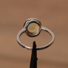 It is a natural opal ring. The main stone is 7mm*9mm oval white opal. The basic metal is sterling silver and plated with rhodium. To change the metal to a solid gold (white/rose) or platinum is also available, please ask for a quotation if you want. You can also go to my shop Home for more elegant rings: https://www.etsy.com/shop/godjewelry?ref=hdr_shop_menu Opal is the birthstone of October, it will be a great gift for your lover! Customization is always welcome and please feel free to contact Elegant Ethiopian Opal Ring With Oval Cabochon, Oval Opal Rings With Polished Finish, Elegant Ethiopian Opal Ring In Oval Cabochon, Elegant Ethiopian Opal Ring Oval Cabochon, Ethiopian Opal Oval Ring For Wedding, Elegant Ethiopian Opal Ring, Oval Cabochon, Elegant Ethiopian Opal Oval Rings, Opal Birthstone Ring Oval Cabochon, Opal Oval Cabochon Ring With Polished Finish