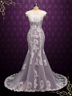 a wedding dress on display in front of a purple background