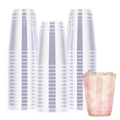 there are many plastic cups and a drink in front of each other