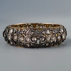 "Antique Victorian Era Rose Cut Diamond Gold & Silver Bracelet. This piece is tested 18K Gold and Silver cast fashion lady's bracelet with 7 inches inner circumference, scoop structure with a 20mm width weighting 43.20 grams. The featured bracelet is bangle style, with beautiful carved flower motif this piece contains bezel set round Rose Cut Diamond measuring average 6mm and weighting approx. 0.55ct each, 42 of them approx. 23.10ct; bezel set oval and pear Rose Cut Diamond measuring average 6.3 18k Gold Bangle, Gold And Silver Bracelets, Pacific Palisades, Bangles Style, Antique Roses, Rose Cut Diamond, Wedding Bracelet, Silver Bangles, Victorian Era