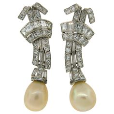 Elegant and classy earrings featuring two natural saltwater pearls set in platinum encrusted with diamonds. The pearls are accompanied with a Gem Testing Report from French Gemological Laboratory stating that the pearls natural saltwater, total weight is 14.46 carats, they are oval shape, white cream color. One is 7.49 carats and measures 9.7 -10.1 x 11.8 mm and the other one is 6.97 carats and measures 9.2 - 9.2 x 11.5 mm. The setting is made of platinum (tested), the backs from 14k (tested) wh Classy Earrings, Platinum Earrings, Saltwater Pearls, Cultured Pearl Necklace, Pearl Set, Women Diamond, Pearl Diamond, Freshwater Pearl Necklaces, Brilliant Diamond