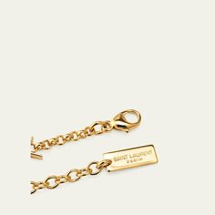 Saint Laurent chain bracelet Shiny brass with a gold-tone finish Features signature YSL logo stations Adjustable length Lobster clasp Imported Gold-tone Plated Jewelry With Logo Plaque, Yellow Gold Chain Link Jewelry With Gold-tone Logo, Yellow Gold Metal Jewelry With Gold-tone Logo, Gold-tone Metal Jewelry With Logo Plaque, Designer Gold Jewelry With Gold-tone Hardware, Luxury Gold-tone Jewelry With Logo Charm, Elegant Gold-tone Chain Link Jewelry With Logo Plaque, Elegant Gold-tone Chain Link Jewelry, Gold-tone Metal Jewelry With Logo Charm