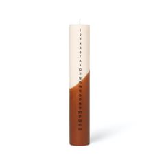 a brown and white candle sitting on top of a table