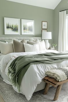 a bedroom with green walls and white bedding