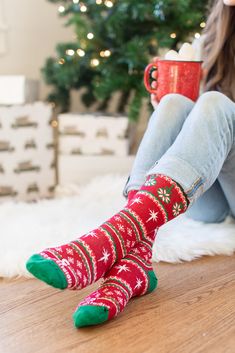 This sock has several hidden gems that can be used as tools for evangelization this holiday season. Along the top, Christmas bulbs contain a single poinsettia. Historically, the poinsettia has been associated with Christmas and is given as a symbol of good will and community spirit. It also represents the star of Bethlehem with the red leaves echoing the blood of Christ. Throughout the sock there is also a repeating pattern of the Star of Bethlehem, a bright star that appeared in the Eastern sky Sock Company, Blood Of Christ, Sweater Socks, Star Of Bethlehem, Christmas Socks, Catholic Gifts, Bright Stars, First Communion, Really Funny Pictures