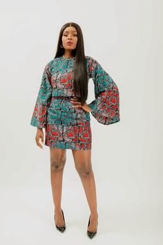 This African Print (Ankara) crop top & mini skirt set is skillfully created from light-weight cotton to offer a perfect blend of captivating charm and fragility. The top features a round neckline and long bell sleeves, while the skirt is designed with a high-waisted silhouette and back zipper. This ensemble makes it easy to enjoy a fashionable and comfortable look no matter the temperature. Set is named after the style of dance from Côte d'Ivoire; Coupé-décalé   100% Ankara wax cotton  Victoria Fitted Multicolor Mini Length Sets, Fitted Multicolor Mini-length Sets, Multicolor Fitted Mini Length Sets, Fitted Cotton Mini Crop Top, Chic Green Cotton Sets, Fitted Cotton Two-piece Set, Ankara Crop Top And Skirt, African Print Crop Top, Ankara Crop Top