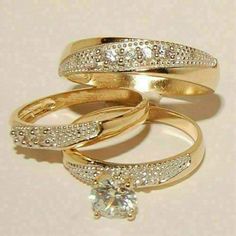 three gold wedding rings with diamonds on each one and a single diamond in the middle