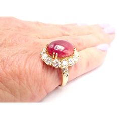 Van Cleef & Arpels 18k Yellow Gold Large Cabochon Ruby Diamond Ring   The Van Cleef & Arpels Fleurette ring is a stunning piece of jewelry crafted from 18k yellow gold and adorned with rubies and diamonds. The ring features a double flower design, with each flower consisting of six petals made from round cut rubies and diamonds. The petals are arranged in a floral shape, creating a beautiful contrast against the gold band. The ring is a perfect accessory for any occasion, adding a touch of elega Luxury Ruby Cabochon Diamond Ring, Formal Hallmarked Diamond Cabochons, Luxury Diamond Cabochons For Wedding, Luxury Ruby Ring With Cabochon Cut, Luxury Cabochon Ruby Ring For Anniversary, Elegant Formal Cabochon Ring, Yellow Gold Diamond Cabochons Fine Jewelry, Luxury Diamond Cabochons For Formal Occasions, Formal Fine Jewelry Domed Cabochons