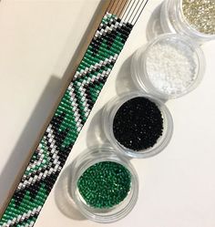 three bowls filled with different types of beads