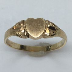 Antique Heart Shape 14K GOLD Signet RIng 1.0 Gram Size 5.25 Never Engraved This antique signet ring is a true beauty. Crafted from 14k yellow gold, it features a heart-shaped design that exudes elegance and sophistication. The ring is perfect for any occasion and is a great addition to any jewelry collection. With a weight of 1.0 gram and a size of 5.25, this ring is a perfect fit for anyone. It has never been engraved and does not feature any diamonds or gemstones. The vintage design adds to its charm and makes it a unique piece. Don't miss out on the opportunity to own this exquisite piece of fine jewelry. 6 mm wide on top Classic Heart-shaped Signet Ring For Wedding, Heirloom 14k Gold Heart Promise Ring, Victorian Yellow Gold Jewelry For Valentine's Day, Vintage Promise Jewelry For Valentine's Day, Classic Heart Cut Signet Ring For Promise, Classic Oval Heart Ring For Valentine's Day, Antique Yellow Gold Heart Cut Jewelry, Victorian 14k Gold Jewelry For Valentine's Day, Heirloom Oval Rings For Valentine's Day