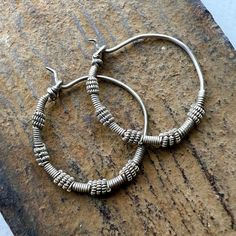 A pair of old silver Hoop earring from Afghanistan - Kuchi people. 28mm  wide - 1 1/8" inches  2mm wire through hole - thicker than Western earwires. 5.8 grams Traditional Adjustable Small Hoop Jewelry, Spiral Nickel-free Hoop Earrings For Everyday, Unique Metal Hoop Earrings, Unique Silver Nickel-free Hoop Earrings, Handmade Silver Metal Hoop Earrings, Bohemian Hand Forged Hoop Earrings For Everyday, Handmade Spiral Silver Hoop Earrings, Traditional Adjustable Hoop Jewelry, Artisan Handmade Silver Hoop Earrings