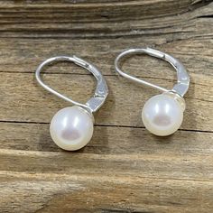 This simple but absolutely elegant earrings are made with freshwater cultured pearls that are an outstanding AA+ quality. They have been mounted on sterling silver lever back earrings. The pearls are slightly over 7mm in diameter. Freshwater Cultured Pearls, Elegant Earrings, Cultured Pearls, Fresh Water, Pearl Earrings, Sterling Silver, Silver