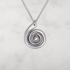 Smooth spiral pendant suspended from an 18" chain Pendant measures 3/4" x 1" Sterling silver or 14k gold fill chain Unique Spiral Sterling Silver Necklace, Modern Twist Swirl Jewelry As Gift, Modern Twist Swirl Jewelry For Gift, Minimalist Spiral Metal Jewelry, Nickel-free Sterling Silver Swirl Necklace, Sterling Silver Swirl Necklaces, Hand Forged Silver Spiral Necklace, Minimalist Nickel-free Spiral Jewelry, Silver Swirl Necklace For Gifting