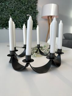 a group of white candles sitting on top of a table