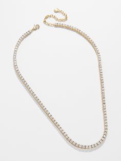 a gold chain necklace with white stones on the bottom and an adjustable clasp to hold it