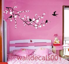 a bedroom decorated in pink and white with birds on the tree branch wall decal