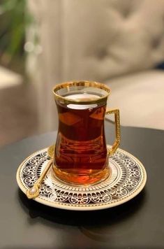 a tea cup sitting on top of a black table