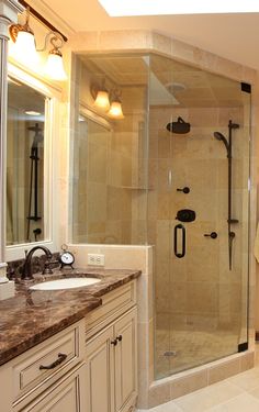 a bathroom with a walk in shower next to a sink