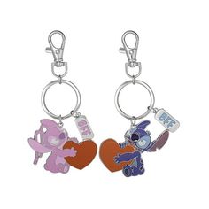 two key chains with cartoon characters attached to them, one has a heart and the other has