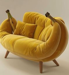 a yellow couch with two bananas hanging from it's back and on the legs