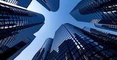 looking up at skyscrapers from the ground