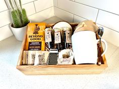 a tray filled with coffee and other items on top of a counter next to a potted plant