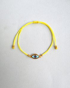 Martis bracelet, Evil eye bracelet Gold enamel charm, Waxed cord March bracelets, Red and White, Twisted string, Greek Tradition Unisex gift The March bracelet is an ancient Greek custom. From the beginning of March, people wear a bracelet made of white and red twisted thread. According to the tradition, the March bracelet protects those from burning of the first sun of spring. The last day of March,the bracelet is left on trees so that swallows can use it for building their nests. Bracelet is m Yellow Resizable Jewelry For Friendship, Gold Braided Evil Eye Bracelet As A Gift, Gold Braided Bracelet With Evil Eye For Gift, Gold Braided Bracelet With Evil Eye As Gift, Resizable Yellow Jewelry Gift, Gold Evil Eye Bracelet With Adjustable Length As Gift, Gold Evil Eye Bracelet With Sliding Knot As Gift, Gold Nylon Cord Friendship Bracelets As Gift, Gold Waxed Cord Friendship Bracelets As Gift