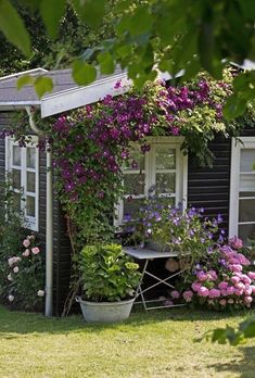 a house with flowers growing on the side of it