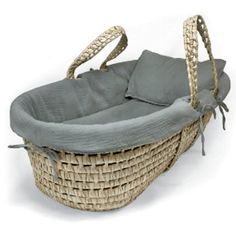 a wicker baby bassinet with grey lining