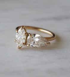 an engagement ring with two pear shaped diamonds