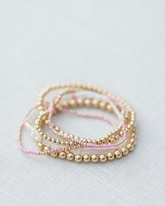 - 2mm gold filled ball beads mixed with color glass seed beads (one pink and gold bracelet) - 6.5 inches Aesthetic Beaded Bracelets, Pink Bead Bracelet, Fantasy Earrings, Preppy Jewelry, Engagement Earrings, Wrist Jewelry, Vintage Jewelry Necklace, Jewelry Accessories Ideas, Gold Jewelry Necklace