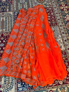 Beautiful orange saree with blue thread chikankaari work by artisans in lucknow India! More colors available Orange Georgette Sharara For Navratri, Orange Georgette Sharara With Traditional Drape, Orange Cutdana Sharara With Traditional Drape, Orange Cutdana Sharara For Diwali, Orange Sharara With Cutdana For Diwali, Orange Georgette Sharara With Cutdana, Georgette Sharara With Cutdana In Orange, Orange Georgette Sharara For Festivals, Orange Georgette Sharara With Zari Work