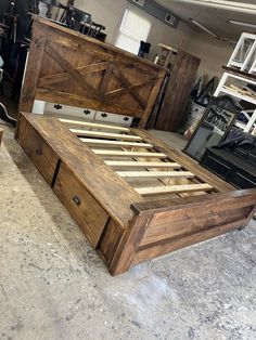 a bed frame made out of wood in a garage