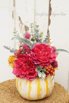 a vase filled with flowers sitting on top of a table