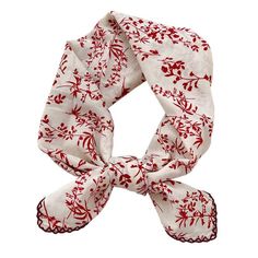 a white scarf with red flowers on it