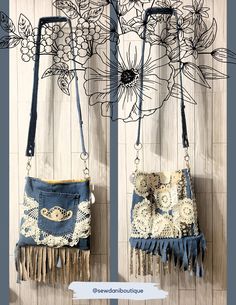 two purses hanging from hooks on a wall with flowers in the back and bottom