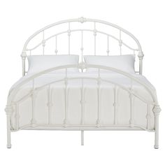 a white metal bed frame with two pillows