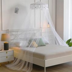 a bed with a white canopy over it