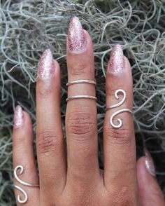 "This listing is for one (1) unique and eye-catching statement ring. The Silver Coiled Midi Ring can be ordered in any normal ring size or midi ring size. Your choice of Silver Plate or Sterling Silver wire is hand shaped in a \"S\" formation, and looks great alone and paired with other rings or alone. Due to the open shape, the ring is slightly adjustable, and great to give as a gift! Specify ring sizes during checkout: An unspecified order will revive a most midi ring size 3/4 Nickel free." Midi Rings Silver, Midi Ring, Midi Rings, Hand Shapes, Stacking Ring, Stackable Rings, Miami Beach, Stacking Rings, Silver Wire