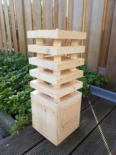 a stack of wood blocks sitting on top of a wooden deck