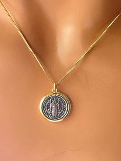 This is a 14 karat gold filled Saint Benedict pendant necklace for women. This Benedict coin actually swivels inside a 14 karat gold filled casing.  This two-tone charm comes with a shiny box chain. Pendant measures 17 mm in diameter. Model is wearing a 16 inch length box chain. Please choose your desired length. Available in 18 inch or 20 inch. If you choose a 20 inch chain you'll receive an 18 to 20 inch adjustable length. In a gift box ready to. St Benedict Necklace Gold, Box Chain Gold, St Benedict Cross, Cross Necklaces, Necklaces Women, St Benedict, Saint Benedict, Protection Necklace, Necklace Box