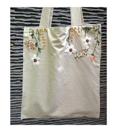 a white bag with flowers on it