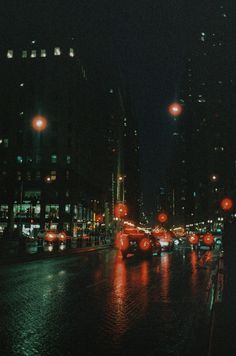 a city street filled with lots of traffic and red lights on top of it at night