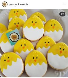 there are many decorated cookies in the shape of chicks on a plate with a tag