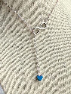 This Silver Infinity Heart Necklace is so meaningful and chic. This Dainty Rainbow Hematite Heart Necklace is the perfect girlfriend birthday. This handmade Lariat Necklace is great for everyday look, it will instantly add an effortless style to your favourite outfit and quickly become your goto, over and over again.The heart charm of the Y necklace is made of hematite, which grounds, protects and makes you feel secure. It provides strength, courage, vitality and endurance. It stimulates concent Trendy Infinity Jewelry, Silver Lariat Necklace With Adjustable Chain As Gift, Silver Sterling Silver Lariat Necklace As Gift, Elegant Lariat Necklace With Silver Chain As Gift, Heart Shaped Jewelry For Best Friend, Blue Jewelry For Best Friend Gift On Mother's Day, Adjustable Personalized Lariat Jewelry, Heart Shaped Adjustable Jewelry Gift, Trendy Dangle Jewelry For Mother's Day